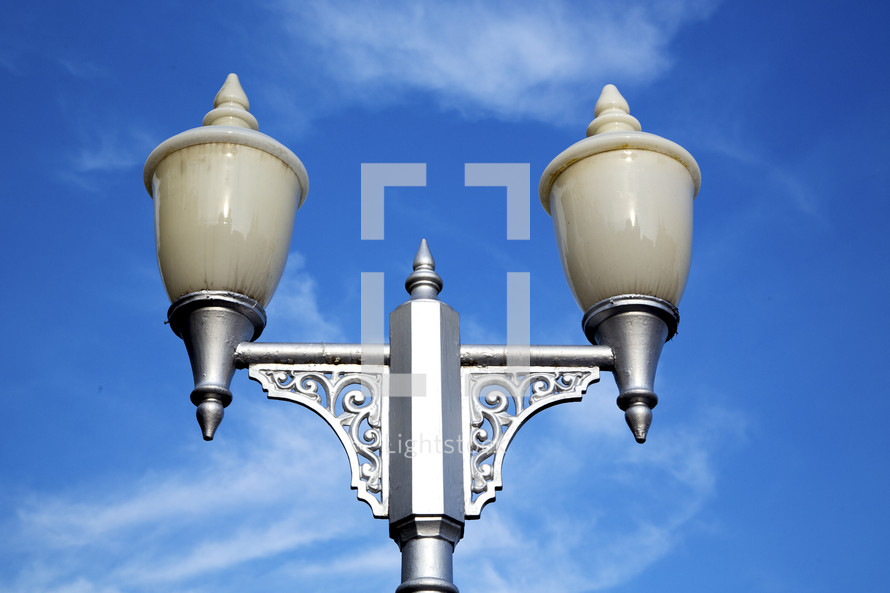 street lamp against a blue sky 
