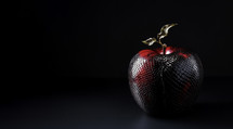 Photograph of a black apple with snake skin texture