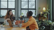 Two Young Bloggers Hosting Podcast in Recording Studio
