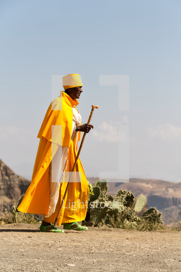 priest walking in the desert in Ethiopia 
