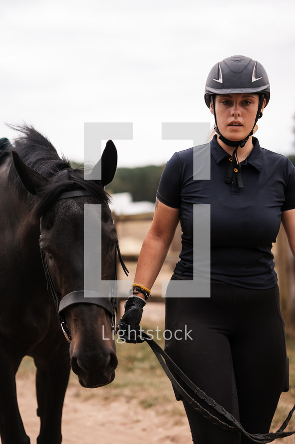 Horse in hand, equestrian woman with a pony, beautiful horse riding equine girl