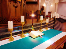 Bible on altar with cross in traditional church