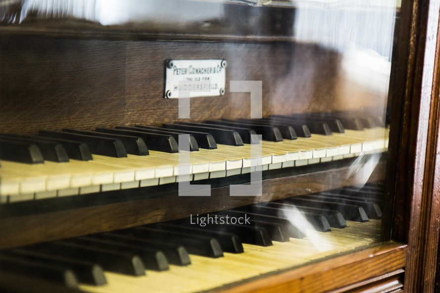 organ keys behind glass doors 