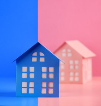 A blue house is divided between two colors, pink and blue for a gender identity concept.