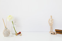 white flower in a clear vase, yarn, stamp, figure, copy space 