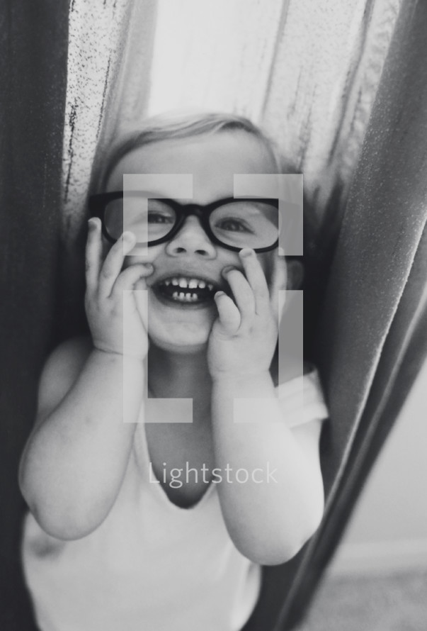 happy toddler in glasses