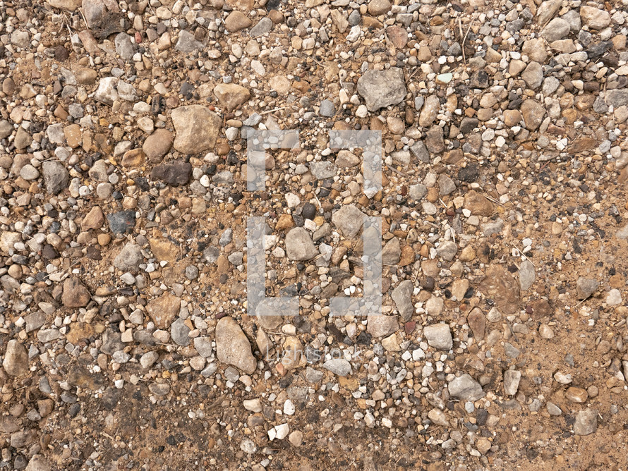 small rocks on sandy ground, natural colors