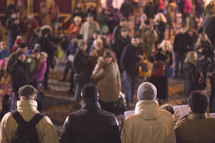 a crowd of people in a city square 