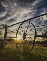 wagon wheel fence and wispy clouds 