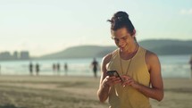 relaxed caucasian man hold use smart phone watching social media at the beach 