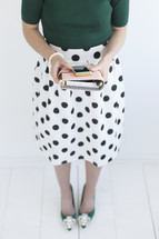 a woman holding a planner and phone 