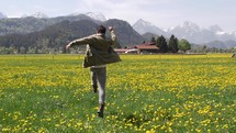 a man frolicking in a field of poppies in Germany 