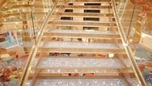 Luxury golden stairway of atrium of a cruise ship. Vacation travel. 
