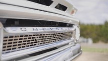 The grill of a classic silver Chevy pickup truck