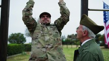 Elderly General Checks The Physical Strength Of The Military Cadet With Pull-ups