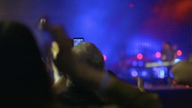 Man recording with phone during concert
