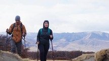 Young couple hiking, trekking in mountains with backpacks, enjoying their adventure - tourism concept 4k
