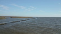 Flocks of Seagulls and Coastal Birds Fly Along the Coastal Marsh in the Gulf Coast of Mississippi. 
