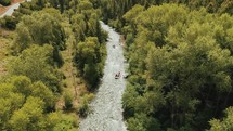 aerial view of a river through a forest in summer 