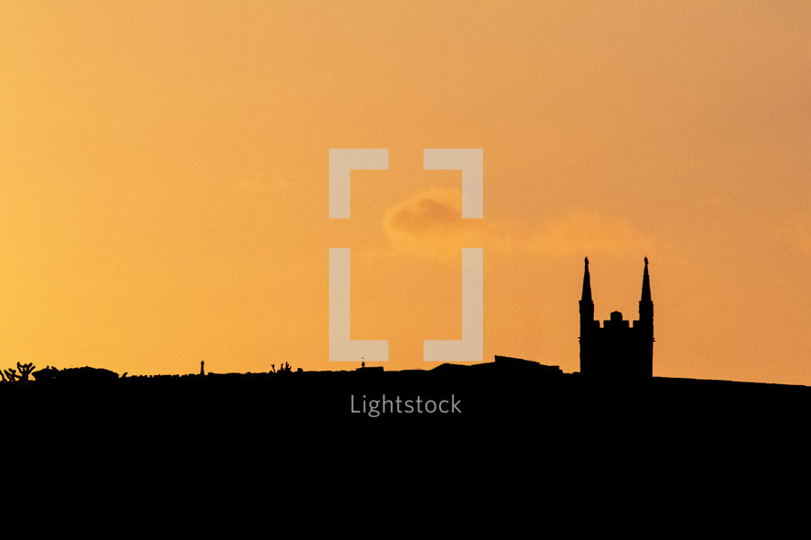 Golden Silhouette of a Church Spire at Sunset