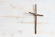simple cross on a white wood background 