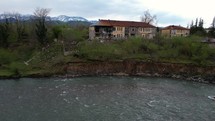 A landslide damaged a house by the river