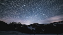Time lapse of star trails in a winter starry, night sky 