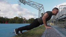 Athlete Does Push Ups In The Stands In The Basketball Court