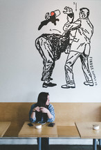 a woman sitting in a coffee shop 