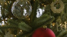 Pan across Christmas tree to the word "believe"