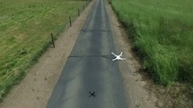 drone flying over a country road 