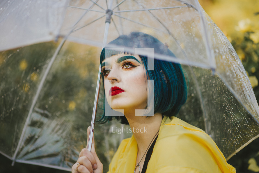 a woman standing under an umbrella 