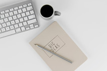 laptop computer, notebook, pen, and coffee mug 
