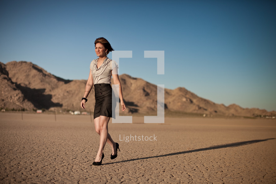 woman walking in heels on desert soil