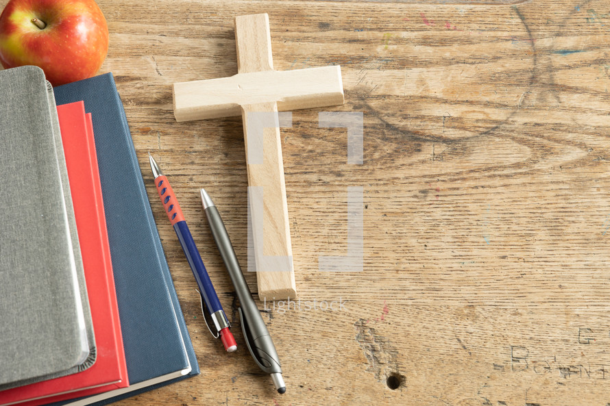 red, navy, gray books, apple and pens and cross