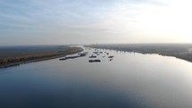 Panorama Of The Ships Sailing On Danube River Amidst The Lush Vegetation At Daytime. aerial