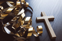 gold streamers and cross on a dark background