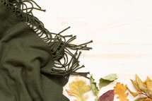 fall leaves on a green scarf 