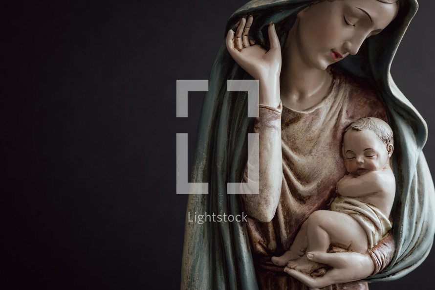 Mary and baby Jesus on a black background