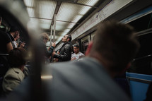 crowds of people on a subway train