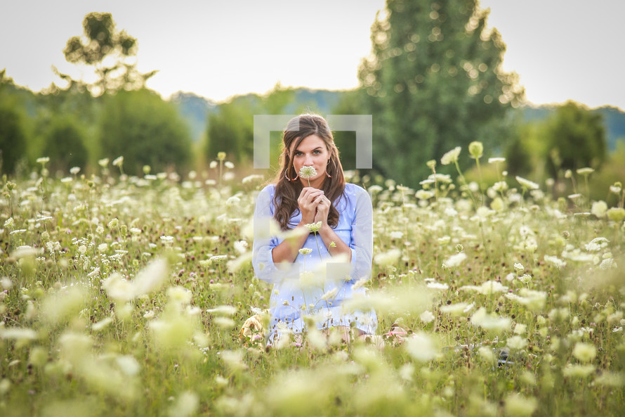 woman standing in a field of flowers 