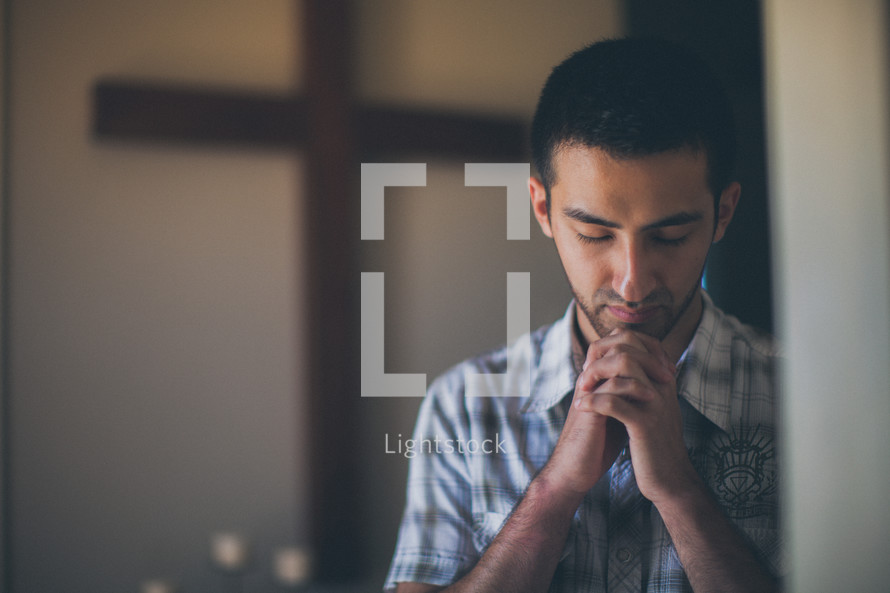 man in prayer in a church 