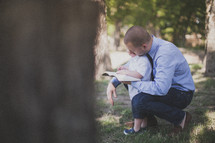 father and son reading a Bible together