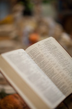 open Bible at a Thanksgiving dinner table 