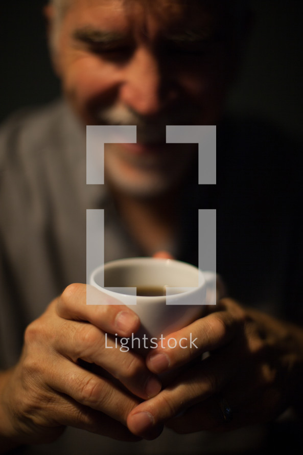 man drinking a cup of coffee in the morning 