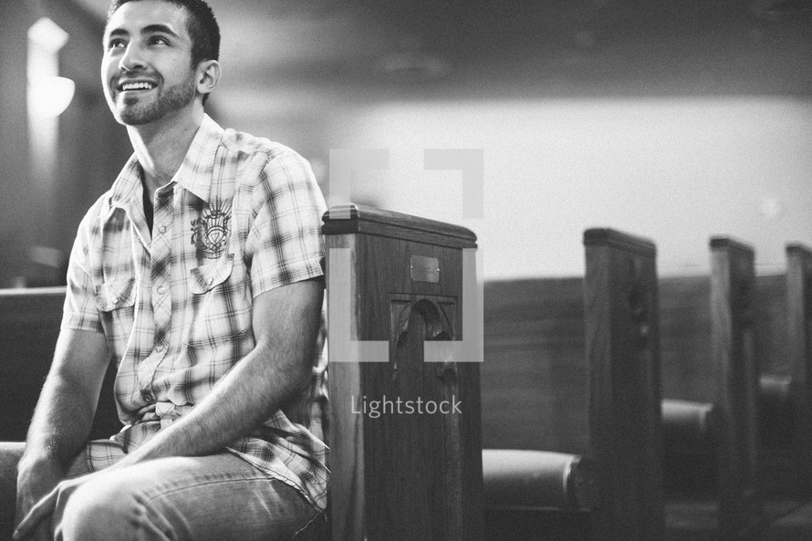 man sitting in a church pew 