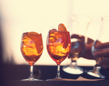 Two glasses of spritz cocktail at sunset