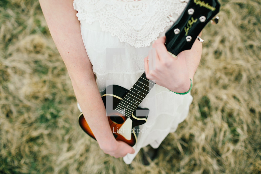 a woman holding a guitar 