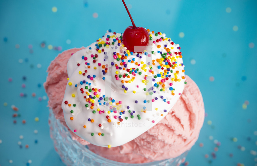 A Strawberry Ice Cream Sundae on a Bright Blue Background with a Cherry on Top