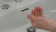 Man carefully washing hands for health safety